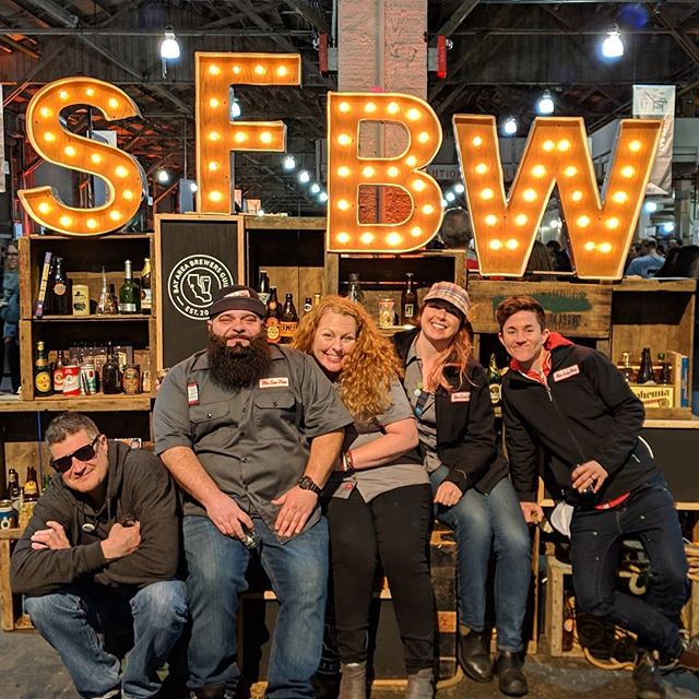 Kevin, Nick, Ali, Jenn, and Lindsey sitting in front of the SFBW sign at San Francisco Beer Week
